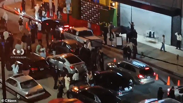 During the chaotic scene early Saturday, people are seen outside their cars