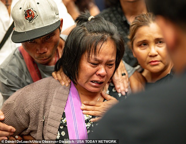 The mother of the 13-year-old boy shot and killed by Utica police cries after listening to an interpreter at City Hall in Utica, New York, Saturday, June 29, 2024