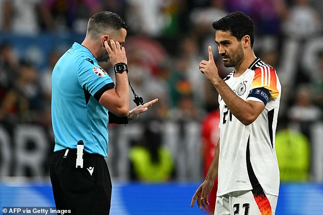 Ilkay Gundogan questions Oliver, who disallows the goal due to a foul by Joshua Kimmich