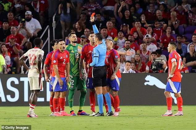 Referee Jesus Valenzuela shows a red card to Chile's Gabriel Suazo in the first half in Orlando