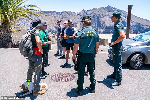 Spanish police and volunteers gather before searching the remote area yesterday