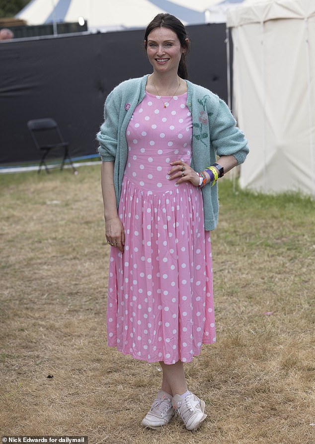 The hitmaker looked stunning in a pink polka dot dress and a green cardigan