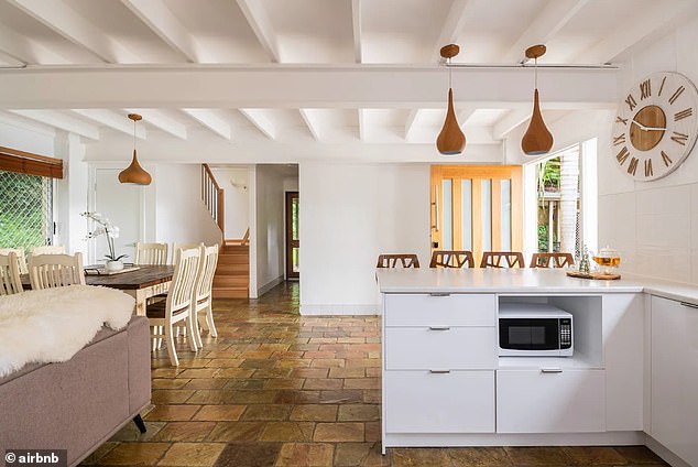 The kitchen in the villa has charming slate tiles and a comfortable dining and sitting area