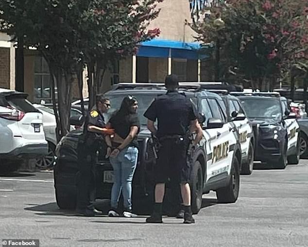 It's unclear which store she entered, but Valezquez said the mother said she left the car running and her boyfriend was in the car with the children. (Pictured: Garza-Amador being handcuffed at the scene)