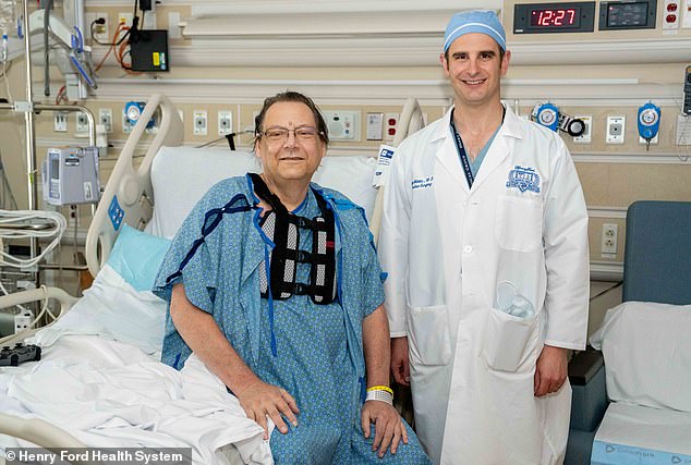 Ken Miller, 58, became the first patient in Michigan to receive a beating heart transplant (pictured here with chief surgeon Dr. Kyle Miletic)