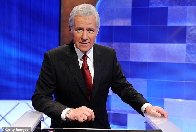 The United States Postal Service has released the late Jeopardy!  host Alex Trebek, shown in April 2010, holding a stamp set to be released on July 22 in honor of his birthday