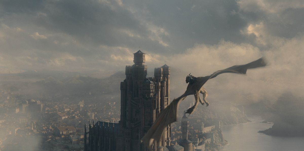 Syrax, a giant yellow dragon, flies through the skies from King's Landing to the Red Keep in House of the Dragon
