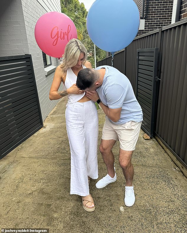 The first sees Josh kissing Ciarne's stomach (pictured), while a second sees the couple happily posing against a fence while holding a pink balloon