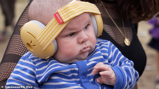 A grumpy-looking baby attending his first rave has become a Glastonbury hit after the grumpy 10-week-old stole the show at Annie Mac's opening performance