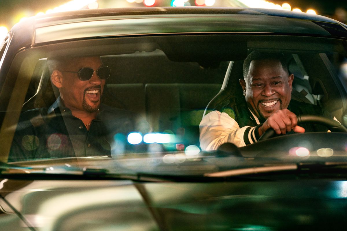 Will Smith sits in the passenger seat as Martin Lawrence drives, as the two laugh in a scene from Bad Boys: Ride or Die.