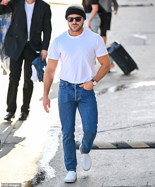 Bearded 36-year-old Zac Efron showed off his muscular physique in a tight white T-shirt and slim-fit jeans in LA on Wednesday