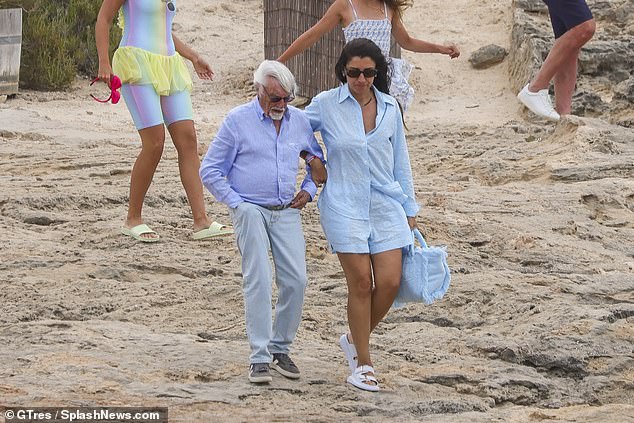 Bernie Ecclestone got a helping hand from his wife Fabiana Flosi on Wednesday as they went on a yacht trip to celebrate his daughter Tamara's 40th birthday in Ibiza