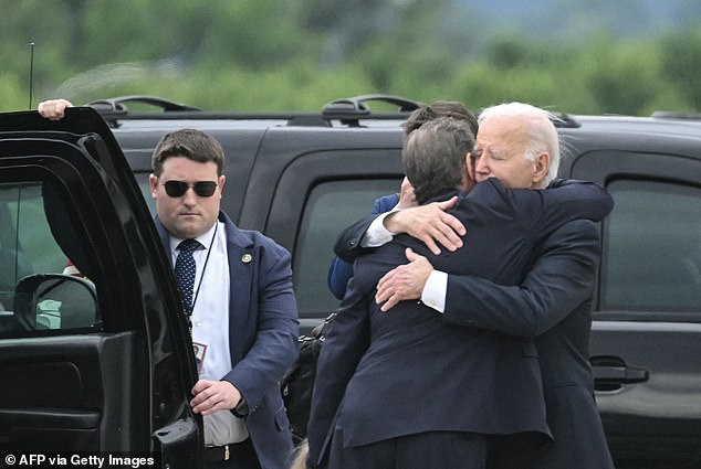 President Joe Biden hugs his son Hunter Biden upon arrival in Wilmington, Del.