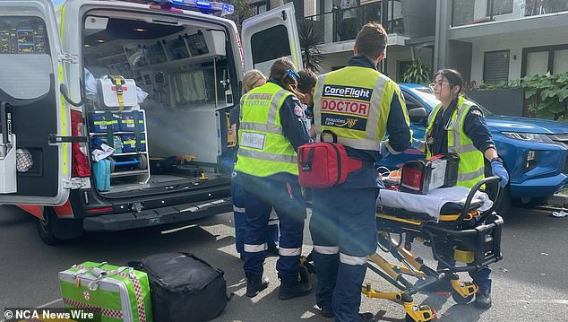 The three-year-old boy was taken by ambulance to Westmead Children's Hospital in a serious but stable condition (pictured, paramedics on scene on Saturday)