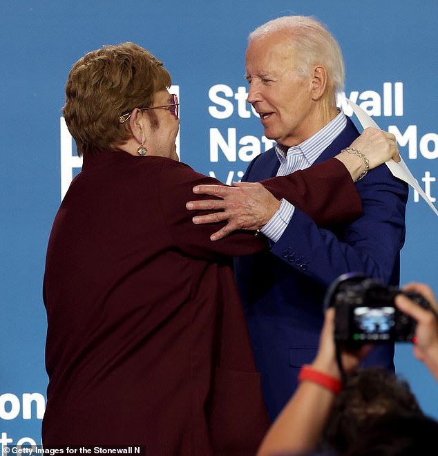 Joe Biden hugs pop icon Elton John at an event on Friday evening as he tries to move on from his disastrous debate performance the night before
