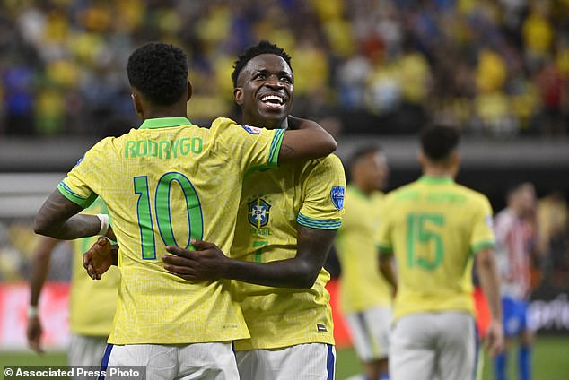 Brazilian Vinicius Junior (R) celebrates his team's third goal with teammate Rodrygo
