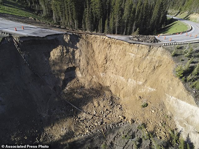 This photo from Wyoming Highway Patrol shows a damaged section of Teton Pass near Jackson, Wyoming on Saturday