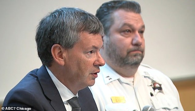 Councilman Brian Hopkins (left) and Chicago Police Commissioner David Koenig had faced demands to crack down on gangs at an angry city hall just two weeks earlier