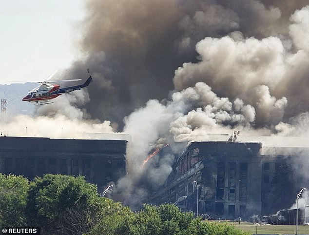 A rescue helicopter flies over the Pentagon moments after the plane hit the building