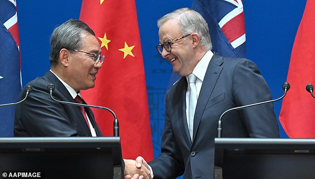 Australian Prime Minister Anthony Albanese shakes hands with China's Li Qiang during a diplomatic meeting in Canberra on June 17
