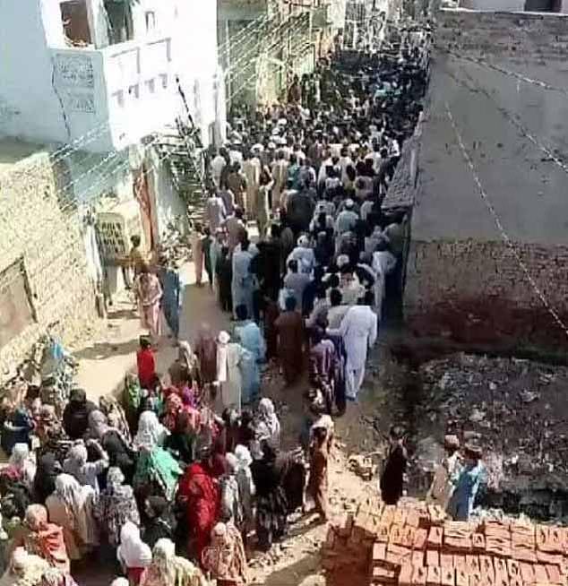 Crowds of people near what is reportedly Nazir Masih's house in Sargodha town, Punjab province, on May 25