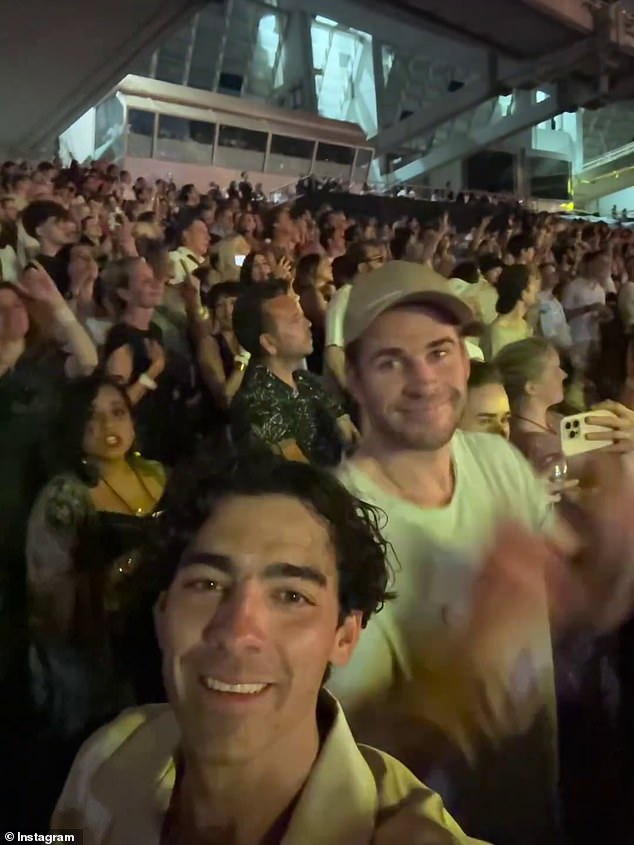 It was A-list when Coldplay took the stage in Athens, Greece on Saturday night as they continued their world tour.  Pictured: Joe Jonas and Liam Hemsworth in the crowd as Gabriella Brooks films the show