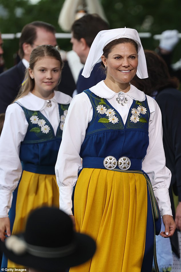 Crown Princess Victoria (right) and daughter Princess Estelle wore traditional costumes for the Swedish National Day