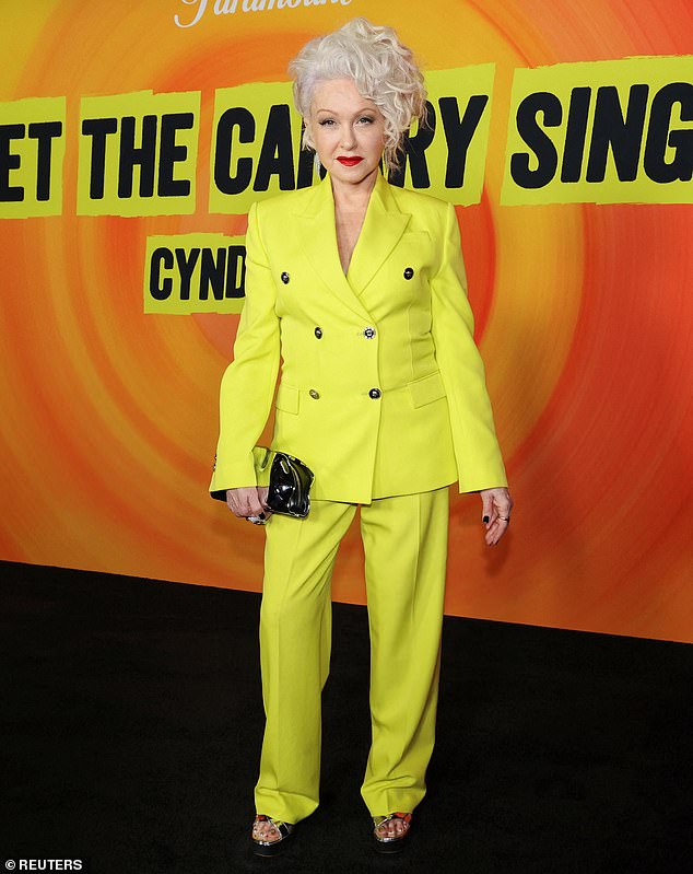 The Time After Time hitmaker put on a dazzling show in a striking double-breasted suit - in canary yellow