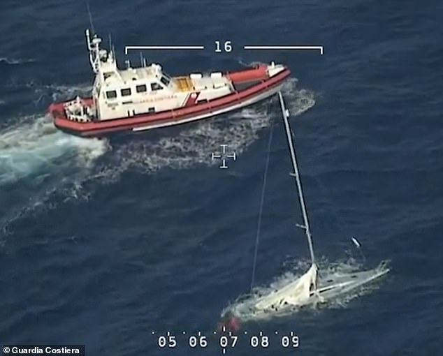 Photos show the sailboat completely submerged with a coast guard boat next to it