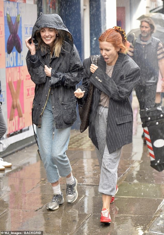 Donna Air and Stacey Dooley were photographed smiling as they braved the heavy rain in London