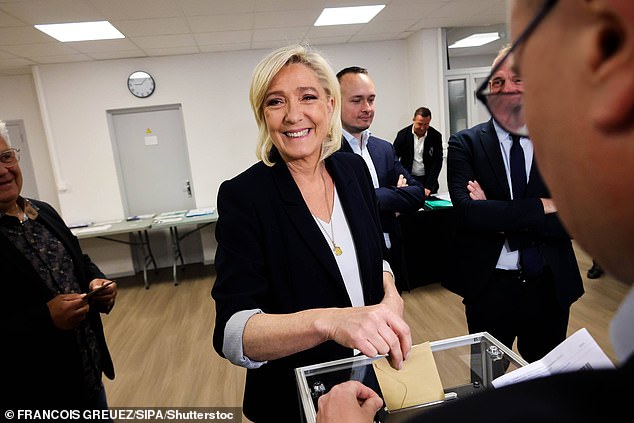 Marine Le Pen introduces herself as she casts her vote in the European Parliament elections on June 9 at a polling station in Henin-Beaumont, northern France.