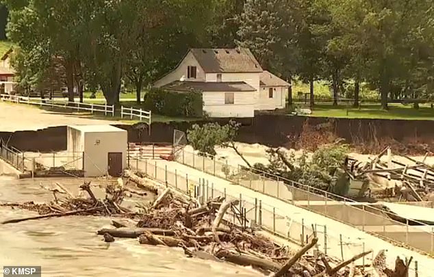 The house where Barnes' father still lives is at risk of being swept away by floods after abnormally high rainfall caused the dam to go into 'imminent failure'.