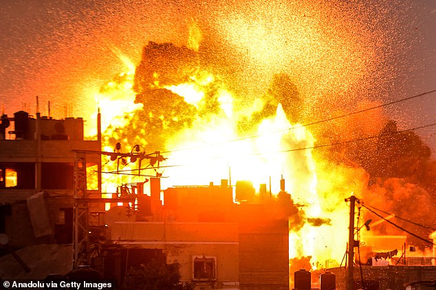 Smoke and flames rise over a destroyed building after the Israeli attacks on the Al Bureij camp in Deir al-Balah