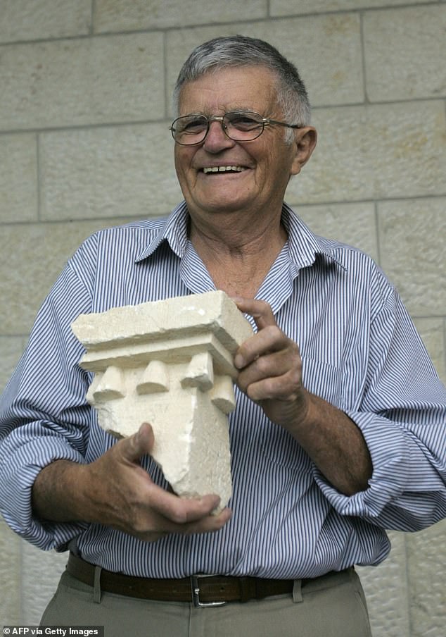 Ehud Netzer holds pieces of an elaborate sarcophagus believed to contain the remains of King Herod
