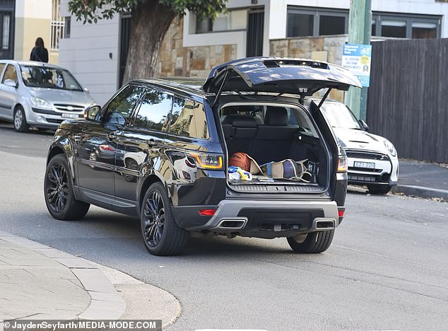 The former Biggest Loser trainer was seen driving away with the boot of her Range Rover wide open as she forgot to close it