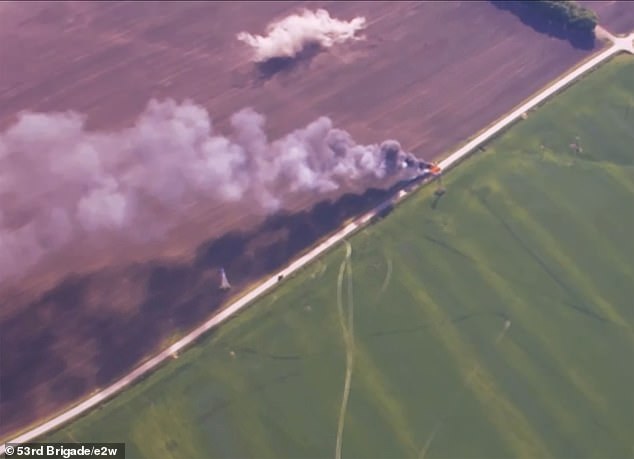 Smoke rises from the defeated convoy, just two miles from the Ukrainian border