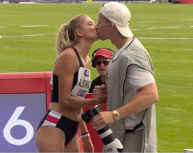 Alica Schmidt (left) stepped outside with her photographer boyfriend Fredi Richter-Mendau (right) as they shared a kiss after her race on Saturday