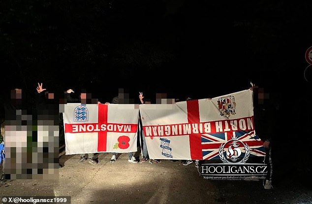 Joyful Serbian thugs appear to display the flags of 'stolen' England fans online