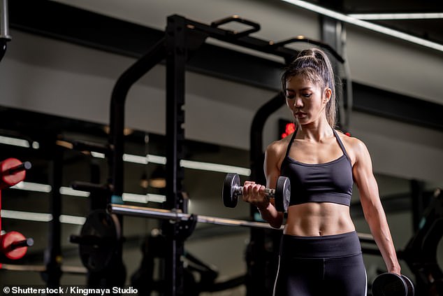 File image of a young woman training in a gym with a barbell