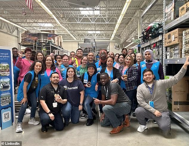 Walmart store manager Greg Harden (second from right, bottom row) and his team pose for a photo.  The Dallas-area store generates more than $100 million in annual sales