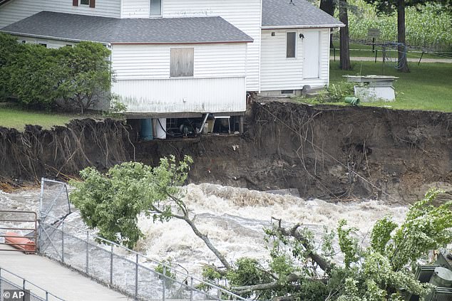 The home, which operated a local store for decades, teetered on the edge of the Blue Earth River when the Rapidan Dam began to give way before erosion destroyed its foundations Tuesday.