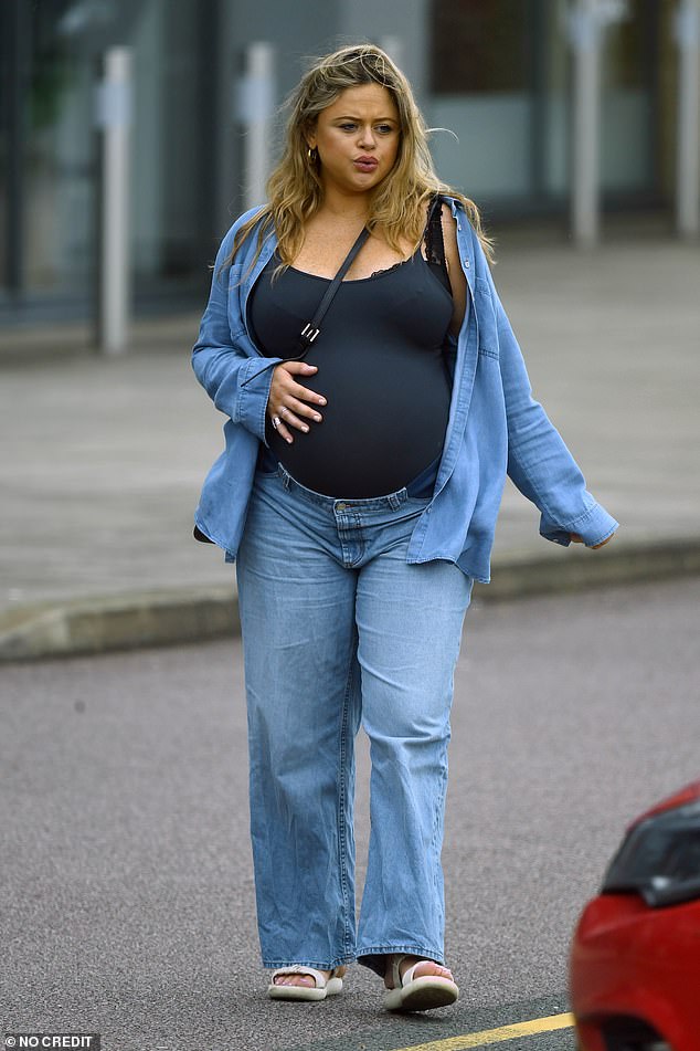 Heavily pregnant Emily Atack, 34, showed off her baby bump as she took a slow walk in North London on Tuesday before welcoming her first child