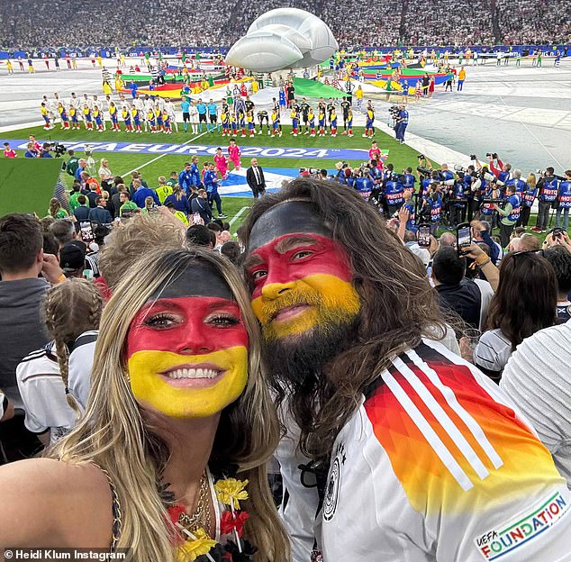 Heidi Klum and husband Tom Kaulitz disguised themselves with face paint in the colors of the German flag as they watched her home country beat Scotland 5-1 at the Allianz Arena in Munich on Friday