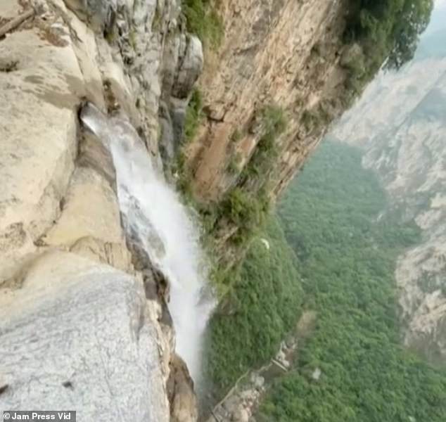 The video, posted on TikTok's sister app Douyin on Sunday, (pictured) showed a large water pipe embedded at the top of Yuntai Mountain Waterfall.