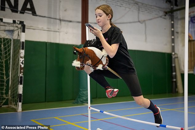 A girl jumps during training at a hobby horse competition in Russia in April