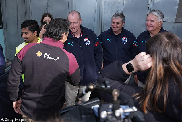 Queensland coach Billy Slater (with back to camera) reportedly left the Blues 'nasty' when he showed up late to a press conference with Michael Maguire on Tuesday (pictured)