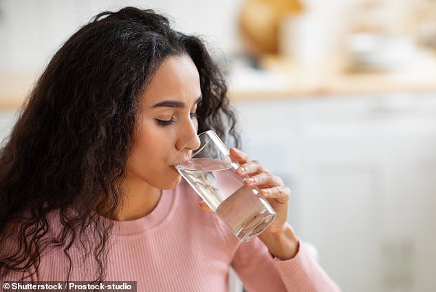 Nearly two million Australians could have been exposed to cancer-causing chemicals found in their tap water, but an expert in the field said there is no need to panic and switch to bottled water.  Stock image of a woman drinking a glass of water