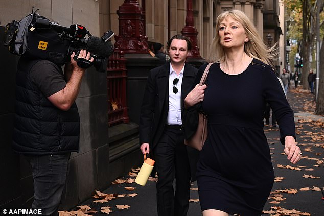 Melanie Lynn makes her way into the Supreme Court of Victoria, past a waiting cameraman