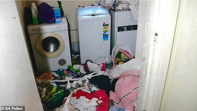 The house was covered in trash, with clothes and other items strewn across the floors and on surfaces, and a filthy kitchen and laundry room (photo)