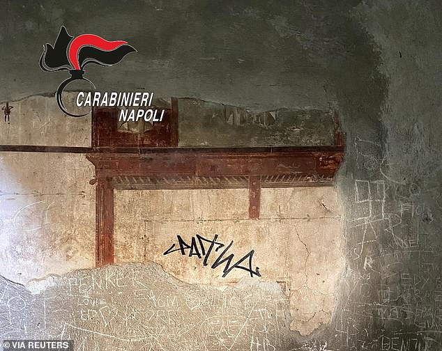 A sign made with a black marker on the wall of a domus of the Herculaneum archaeological park, in Ercolano, Naples, Italy